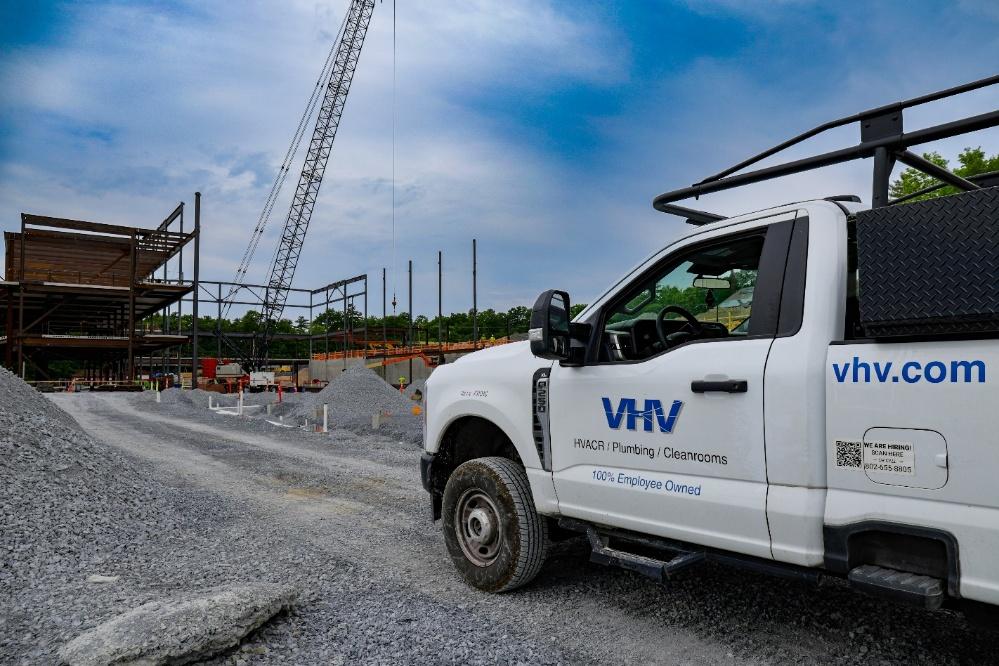VHV truck on site with crane and steel framing